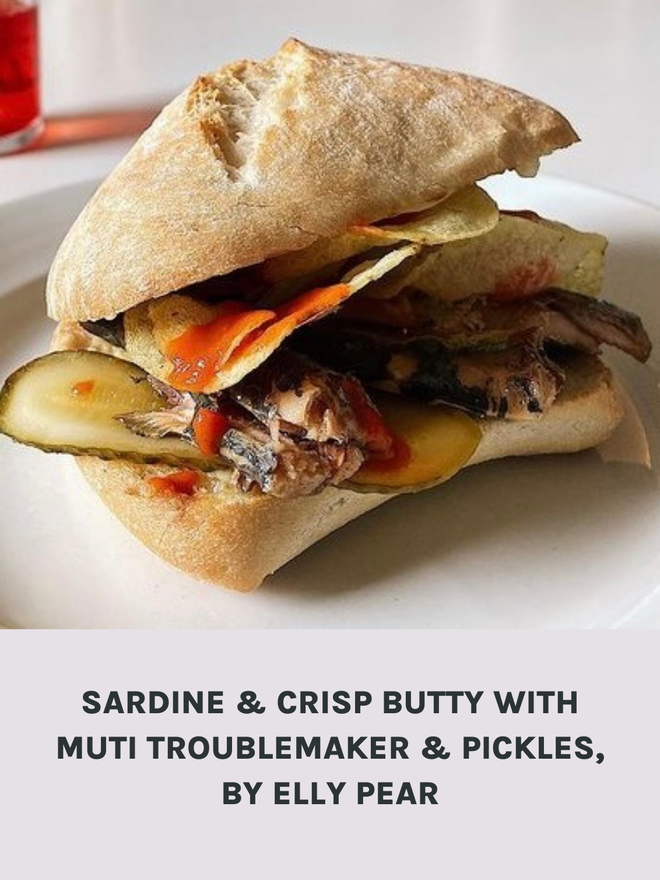 Picture Of A Sardine And Crisp Butty With Pickles And Muti Troublemaker Hot Sauce.