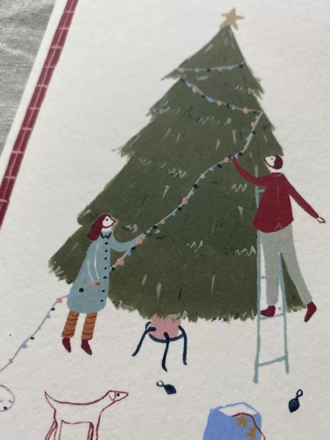 people decorating a christmas tree