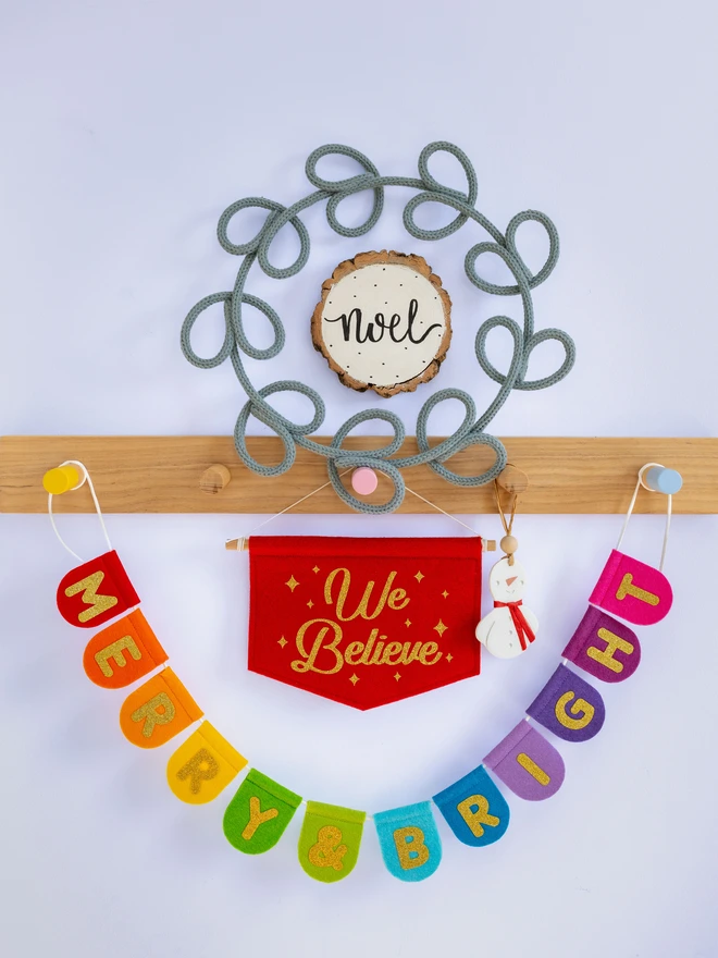 Rainbow Christmas bunting that reads 'Merry & Bright'