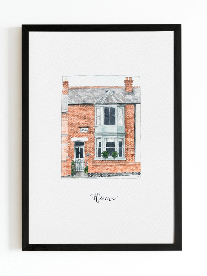 Black frame with white page inside and a beautiful edwardian style house in the centre painted in intricate watercolour details. Below black calligraphy lettering reads home