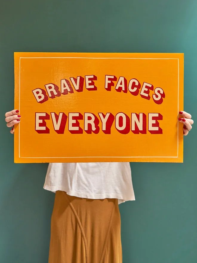 Brave faces everyone hand painted sign