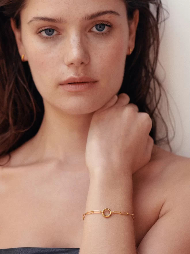 woman wearing gold bracelet