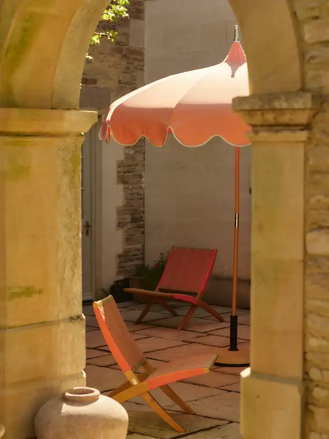 Burnt coral lounge chair in courtyard