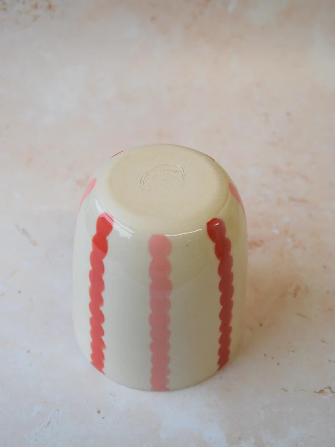 Handmade ceramic Stripe Pop tumbler — base view showing red stripe and maker’s mark