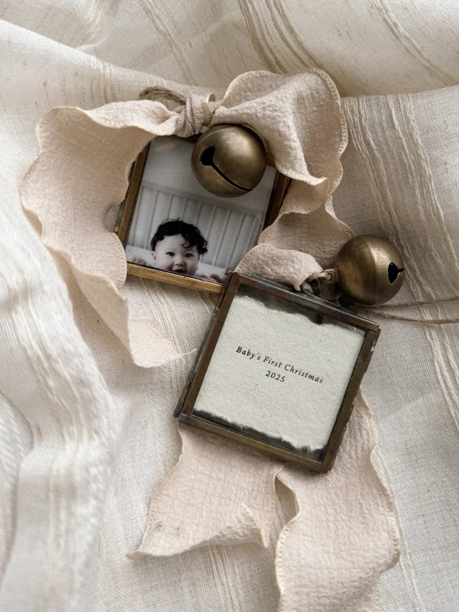 Personalised baby's first Christmas hanging frame. Letterpress printed with a photograph in a bronze frame.