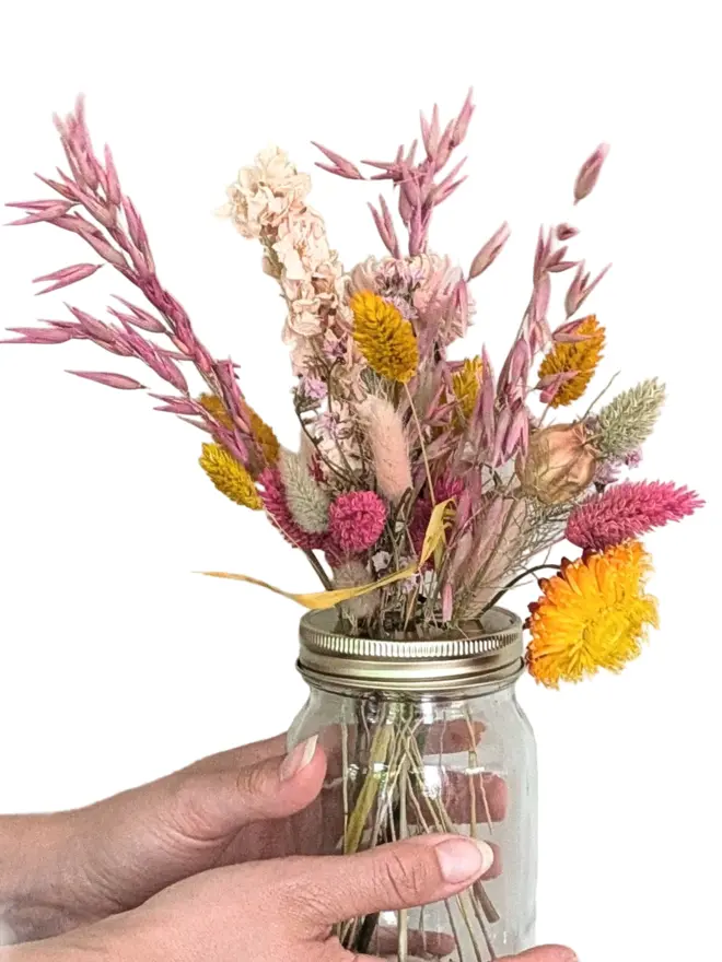 Dried flowers in mason jar with daisy lid