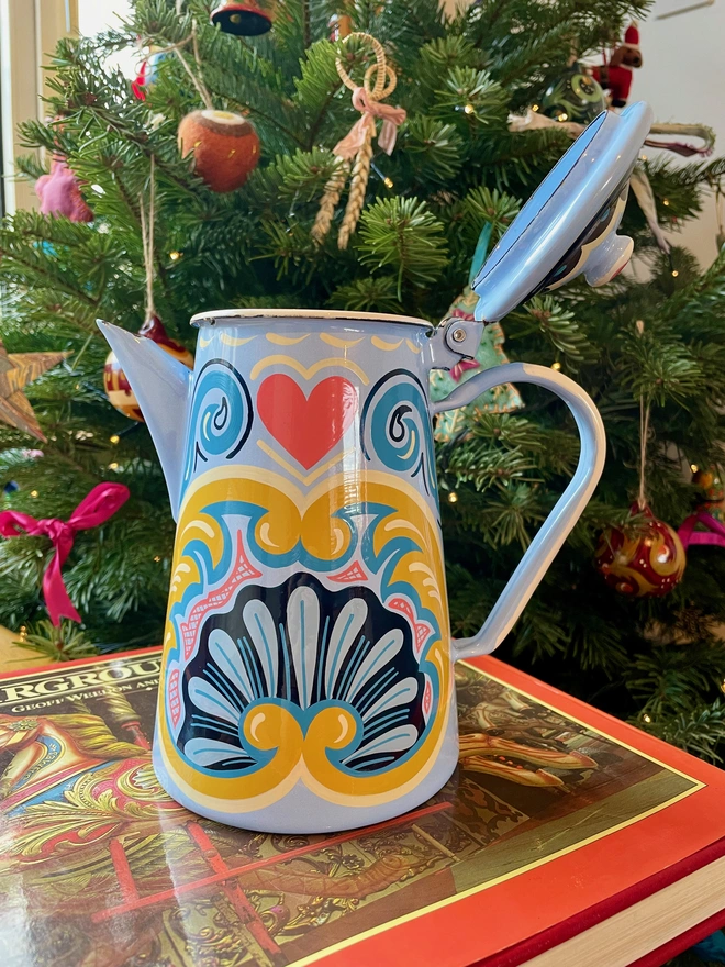 Blue enamel coffee pot hand painted with a fairground design in blue, pink and yellow