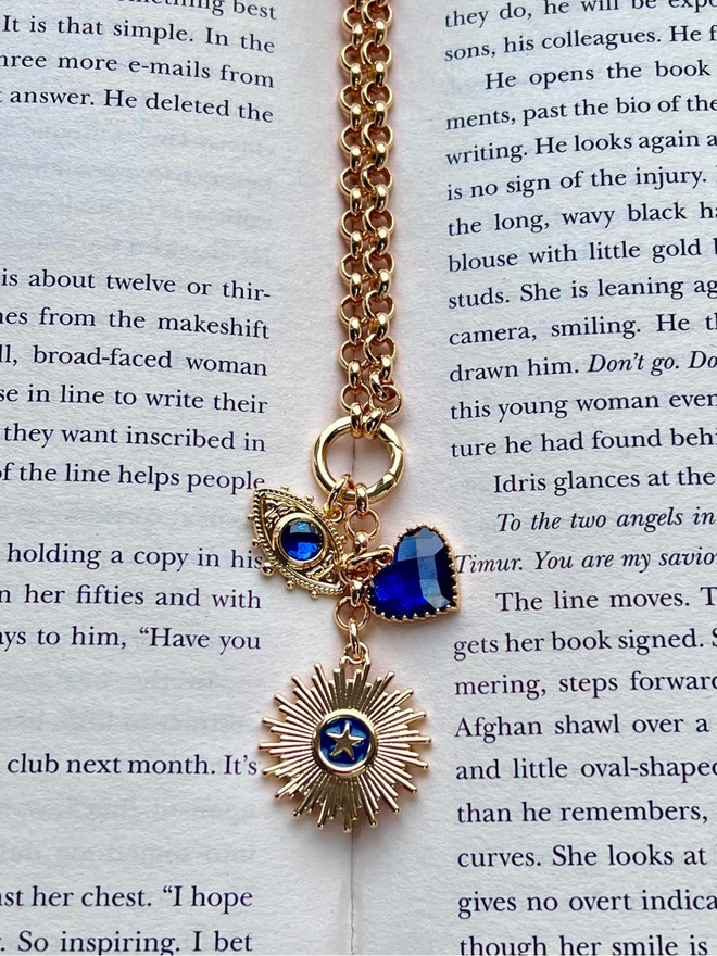 Gold belcher chain necklace with three blue and gold charms