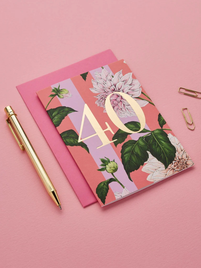 floral age milestone card. a pink floral 40th birthday card photographed against a pink background.