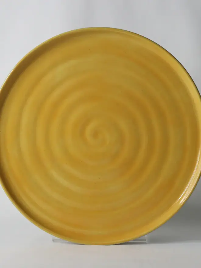 dark yellow ceramic plate with textured swirl design