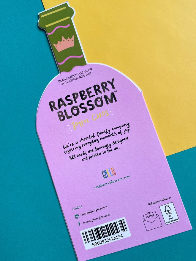 The reverse of the die cut wine shaped birthday card has a small blurb about Raspberry Blossom, a cheerful family company inspiring everyday moments of joy