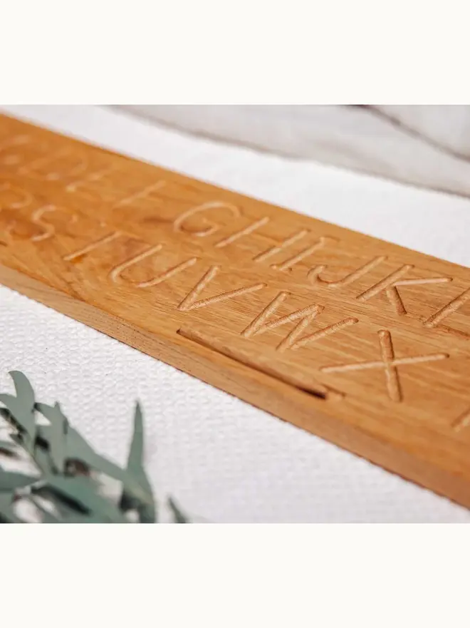 Wooden Alphabet Tracing Board Heirloom Toy, on a table. 