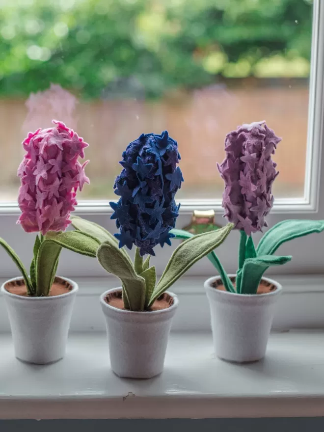 Little Egg teal Felt Faux Hyacinth Plants seen on a windowsill.