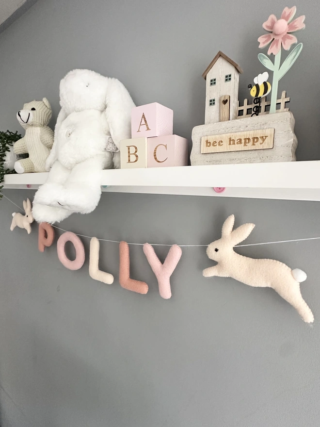Personalised Name Garlands with a bunny at each end, in peachy pinks, child’s name banner hanging, nursery decoration, baby gift, kids bunting