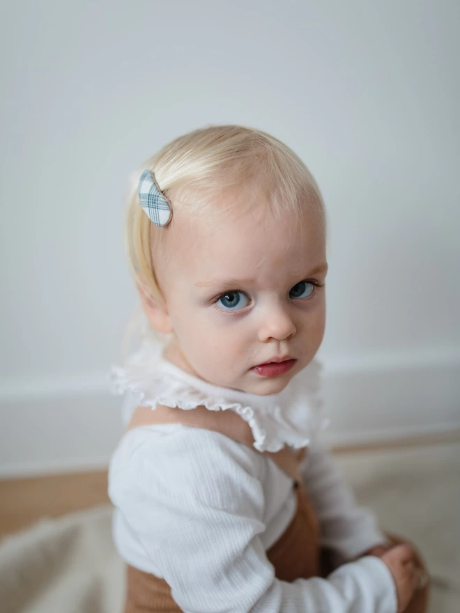 close up of toddler with set of three hair clips