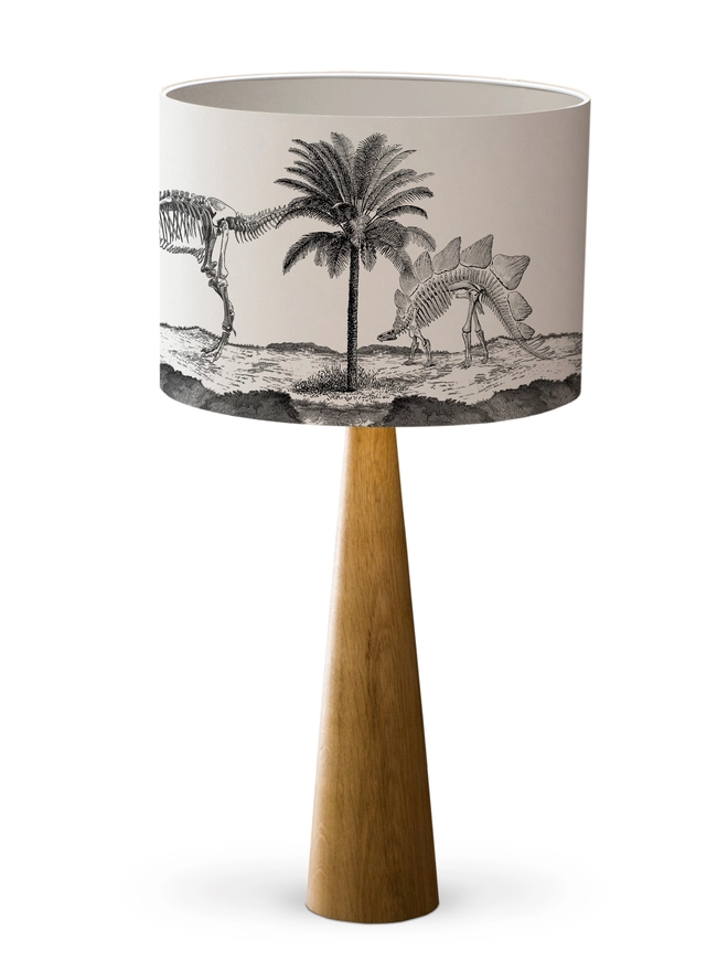 Drum Lampshade featuring Dinosaurs with a white inner on a wooden base 