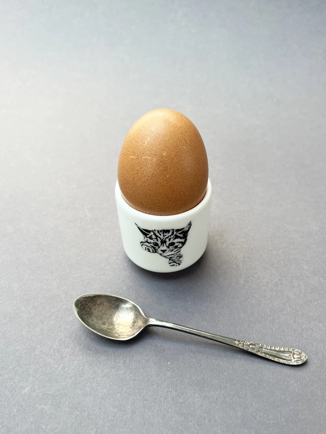 Cat egg cup with spoon in front