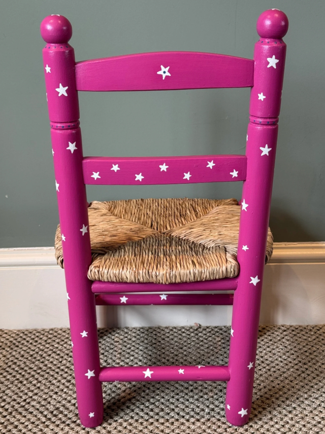 Ellie Chair. A dark pink chair patterned with white stars.