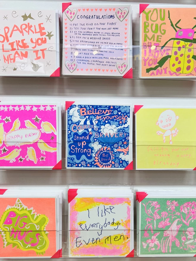 A riso printed card called Believe In Yourself with positive affirmations in a rack 