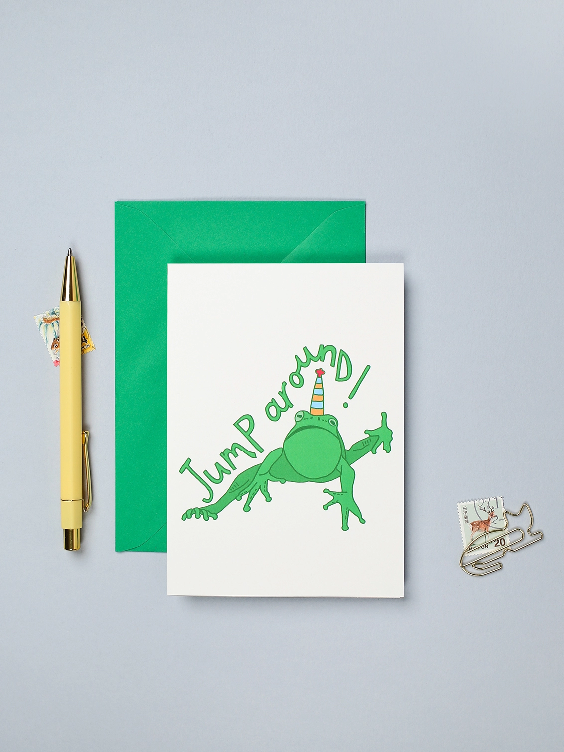Colourful card for a party or birthday featuring a jumping frog in a party hat