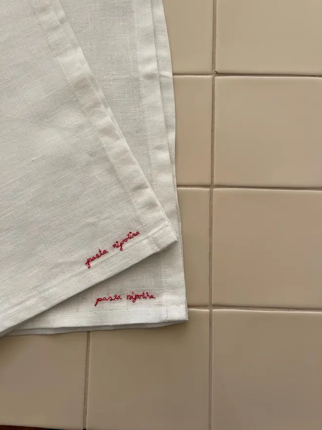 Personalised Hand Embroidered Linen Napkins (Set Of 2), two white napkins with a red personalised message