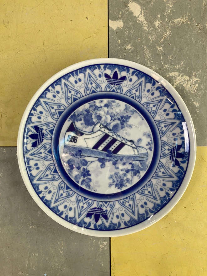 The plate shown lying flat on a grey and yellow background.