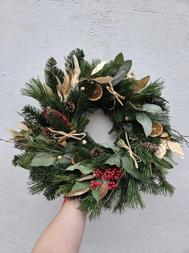 green wreath with christmas foliage