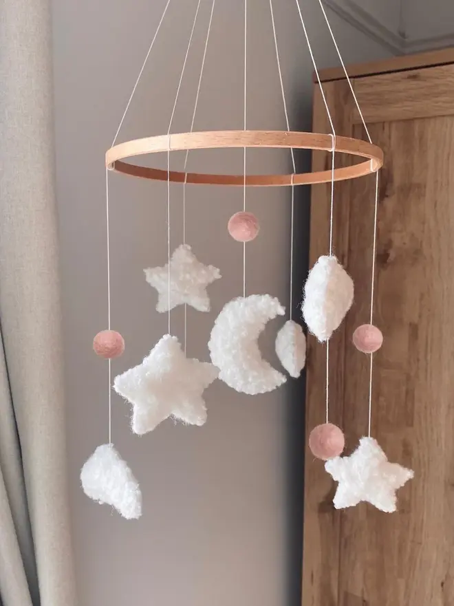 'sweet dreams' boucle baby mobile. a baby mobile hanging from the ceiling with moons, stars and clouds.