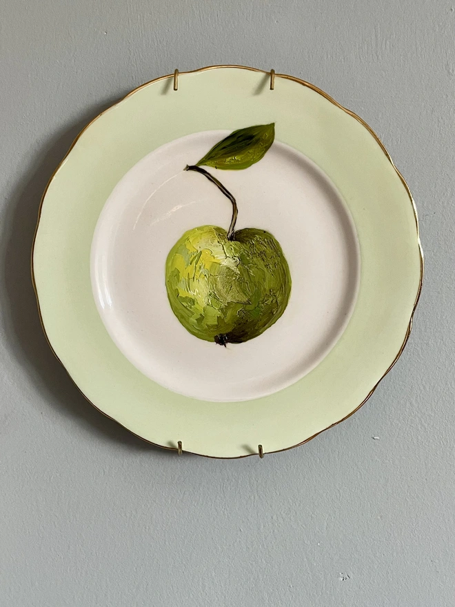 green apple painting on plate