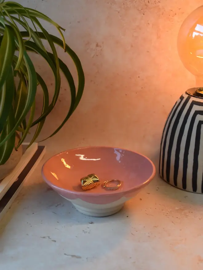 Handmade scalloped edge trinket dish in red and pink - styled with jewellery