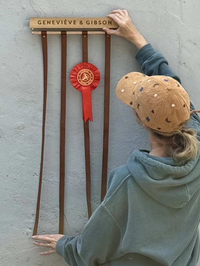 long rosette holder made by modo against a grey wall 