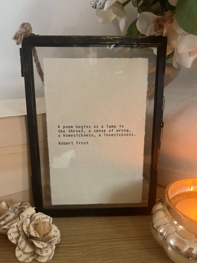 Framed Robert Frost poem, framed in a rustic black hanging frame with gold brush detailing. The print is hand typed with a vintage typewriter onto handmade cotton rag deckled paper.