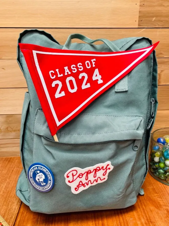Class of 2024 mini pennnat flag in red on a school bag
