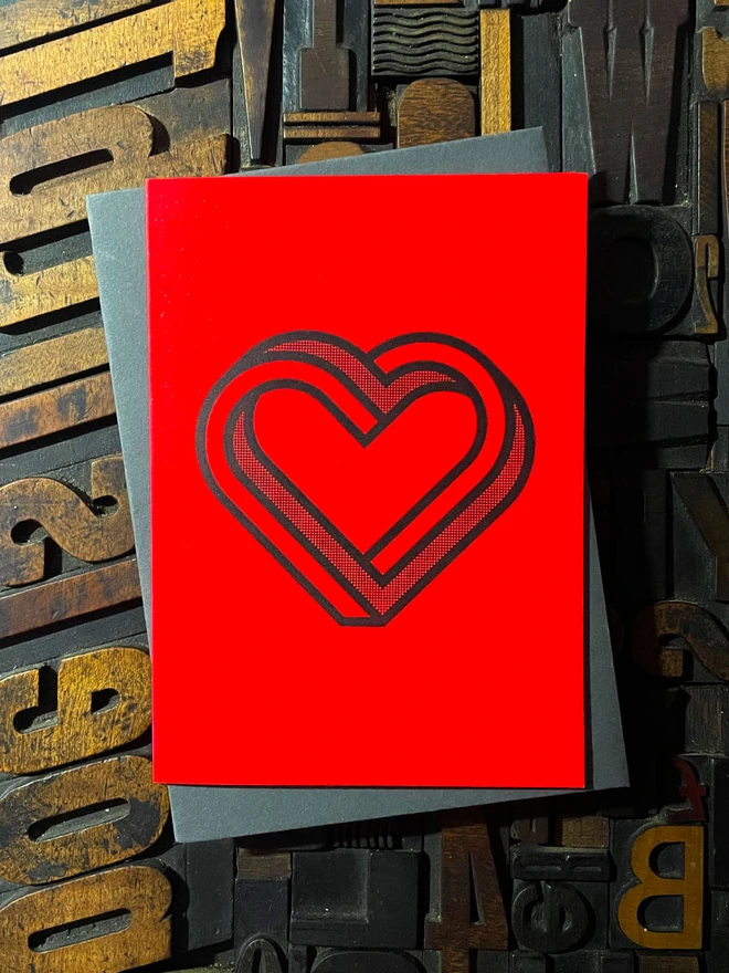 Valentine! A beautiful infinity heart monogram letterpress card printed with rich black ink on thick vibrant Gmund Action Electric Blood colourful card with a luxury matching envelope; ideal to send a to a friend or loved one.