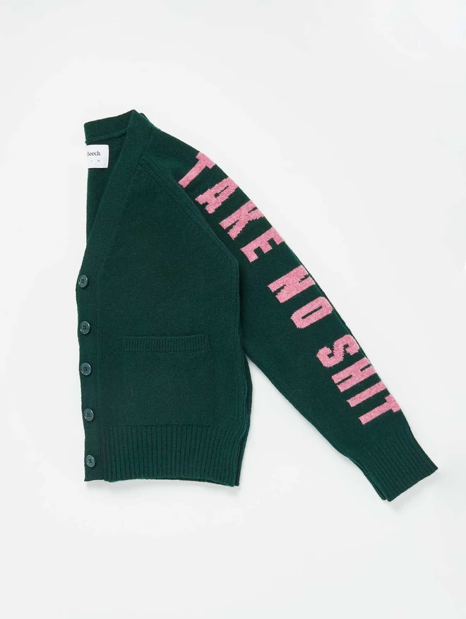 Black & Beech Forest Green Cardigan. Left hand sleeve shows the words Take No Shit written in French Rose 