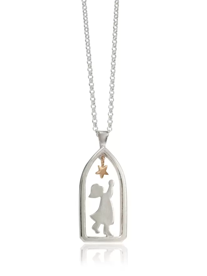 Product image of silver chain suspended with hanging pendant. Pendant frames sillouhette of child in archway reaching towards a hanging golden star. 