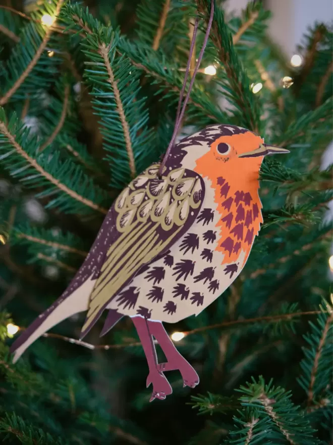 Winter bird decoration perched on Christmas tree