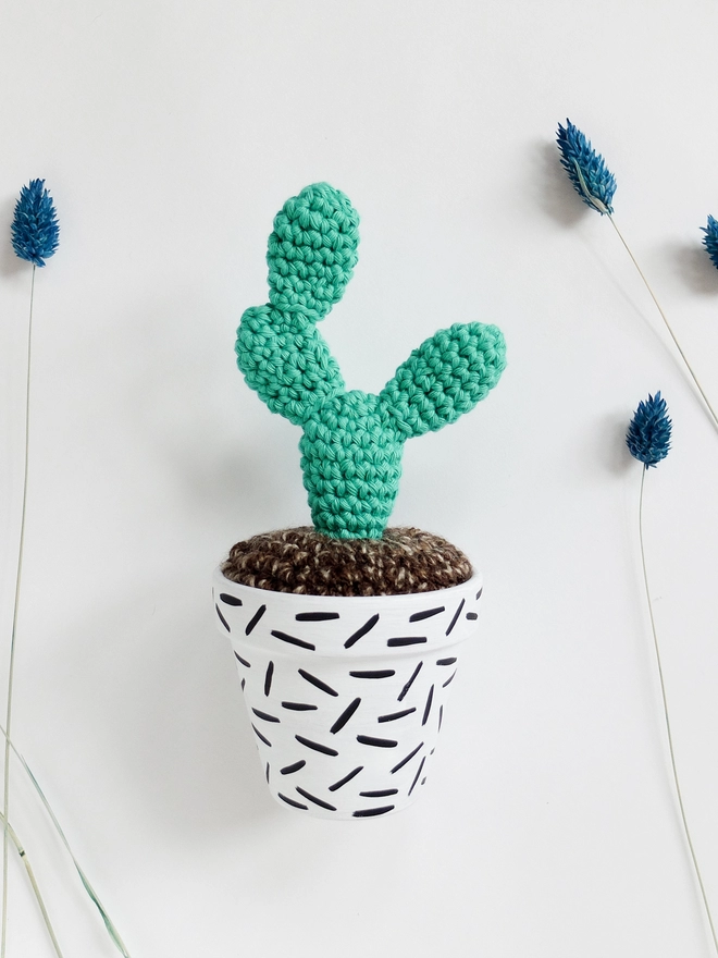 Crocheted cactus in hand-painted pot with dash design