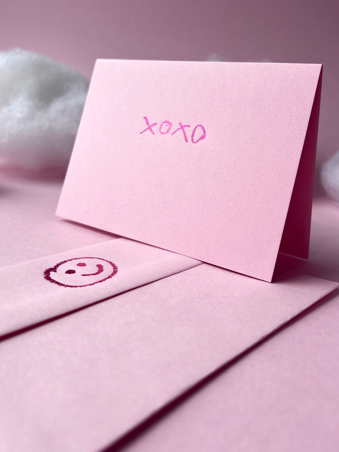 candy pink coloured card with xoxo hand foiled in kids hand writing