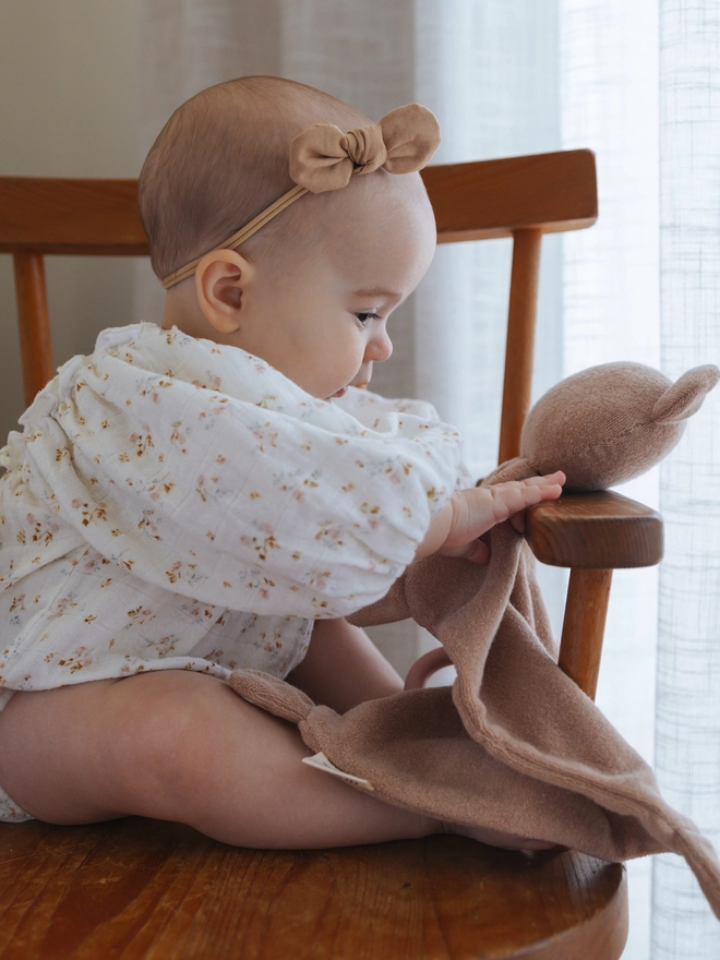 Baby with teddy lovey toy