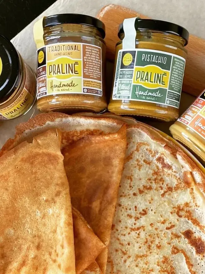 Almond & Hazelnut Praline Spread, next to pancakes. 