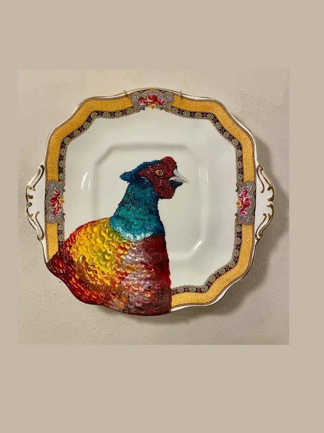 Oil Painted Pheasant On A vintage Taylor & Kent Cake Plate hanging on a beige wall. 