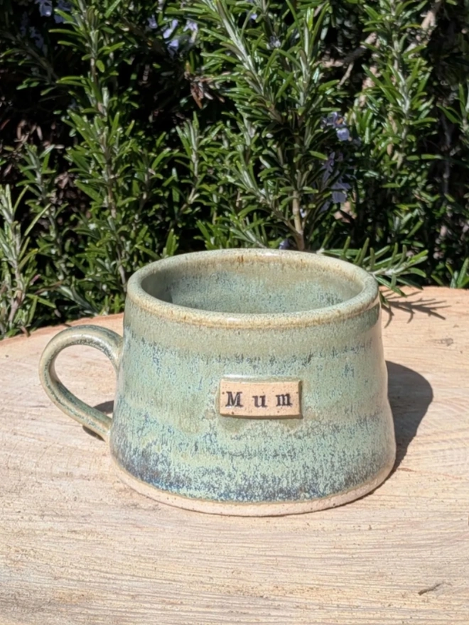 Personalised Stoneware Coffee Cup. A rustic handmade mug in meadow green.
