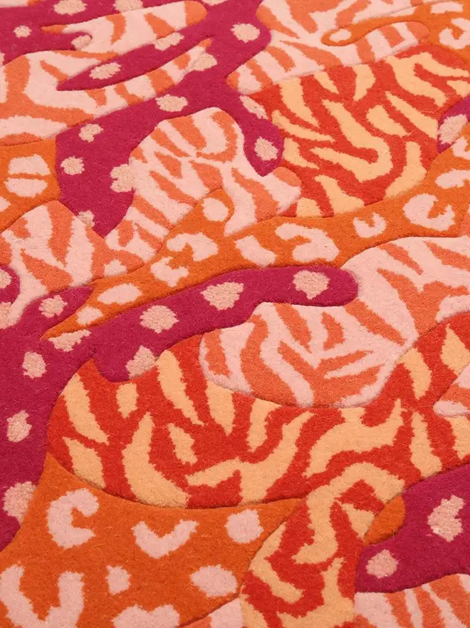 Big Cat Camo Hand Tufted Rug, a colourful rug sitting on a plain surface. 