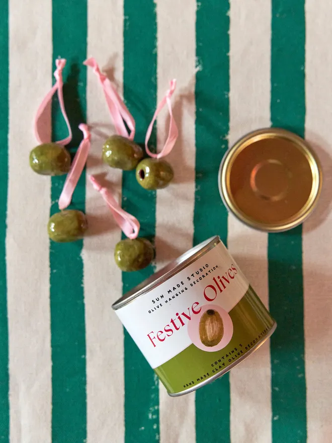 Decorative festive olives on a green and cream stripped tablecloth