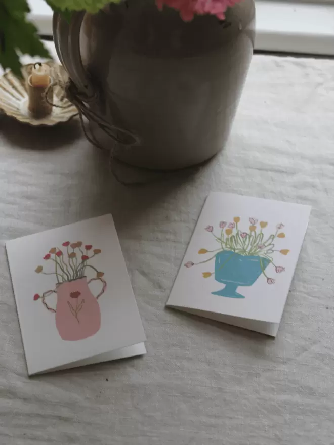 2 cards with ranunculus and tulips of vases. 