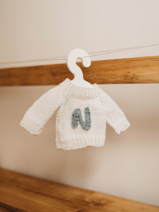 hand knit white personalised teddy bear jumper on toy hanger