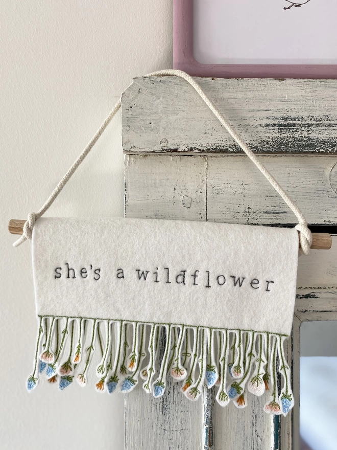 shes a wildflower banner displayed on doorframe
