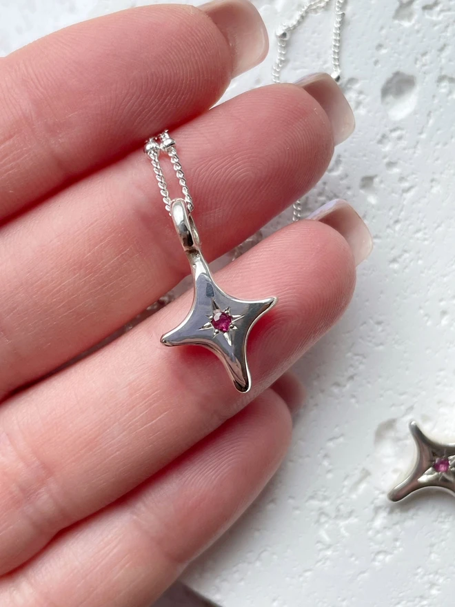Handmade 'You're A Star' charm necklace made from 100% recycled sterling silver, set with a Ruby, the birthstone of July. A perfect gift for your friend, girlfriend or wife for their birthday or just to remind them how much you love them! Add a personalised initial and send straight to your special someone. Made by Celina C Jewellery, a small business in the UK, find on Holly and Co.