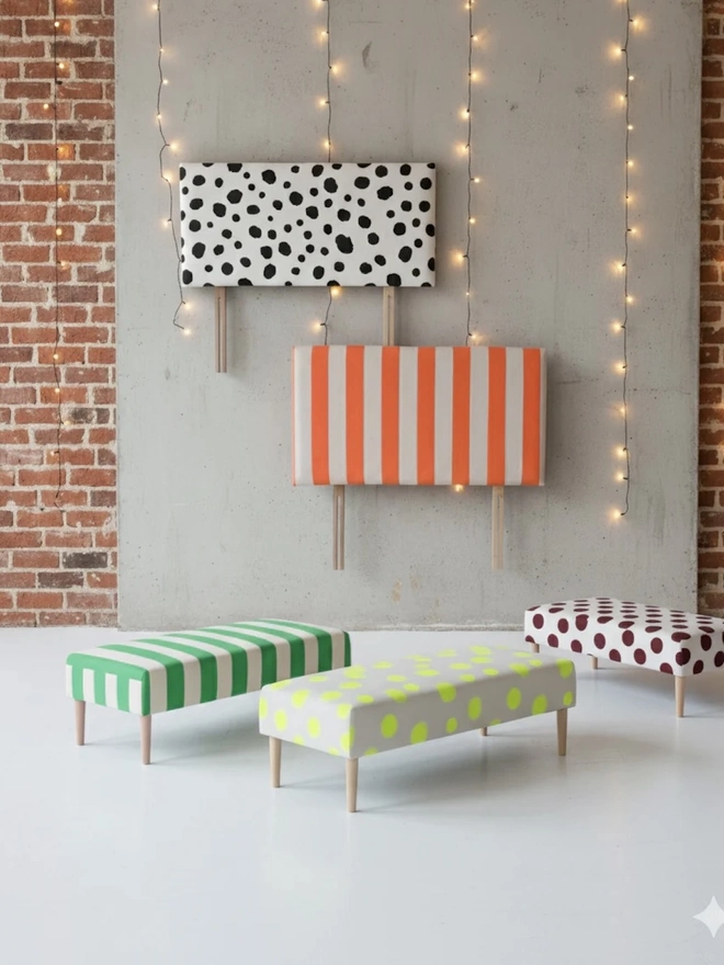 Hand Painted Upholstered Linen Headboard In Stripe Print, a striped headboard hanging against a white surface accompanied by other striped furniture items. 